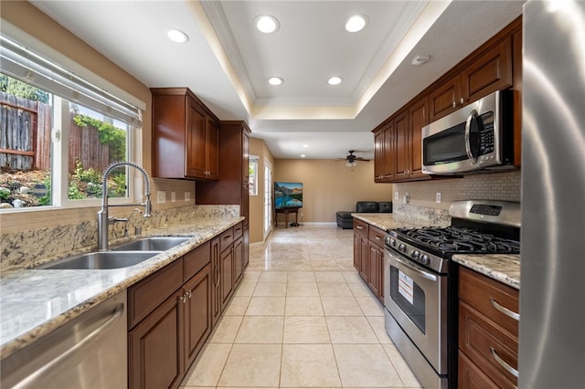 45628 Gleneagles Ct, Temecula, CA 92592 - kitchen featuring appliances with stainless steel finishes, a sink, recessed lighting, tasteful backsplash, and a tray ceiling