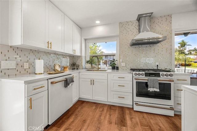 kitchen featuring wall chimney range hood, a sink, gas stove, dishwasher, and tasteful backsplash