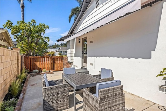 view of patio with fence and outdoor dining area