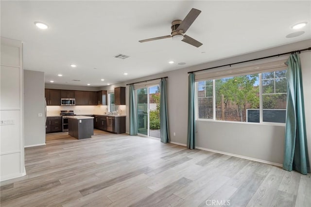 unfurnished living room with ceiling fan, light wood finished floors, recessed lighting, baseboards, and visible vents