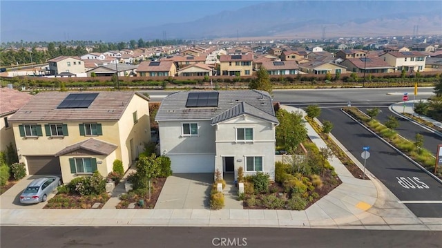 birds eye view of property with a mountain view and a residential view