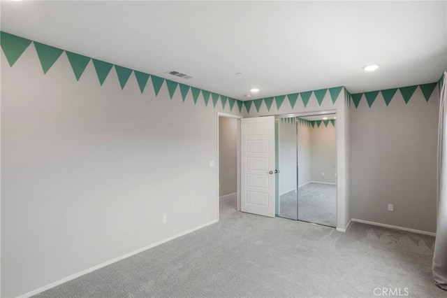 unfurnished bedroom featuring carpet, recessed lighting, baseboards, visible vents, and a closet