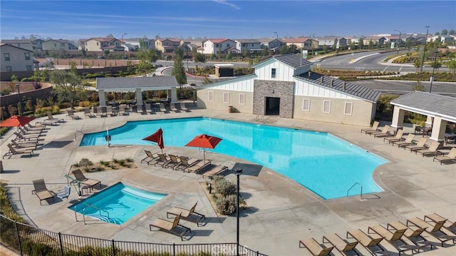 pool featuring fence, a pergola, a patio, a gazebo, and a residential view