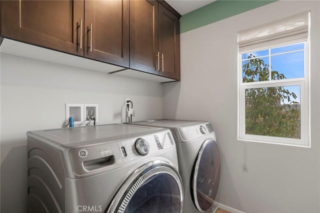laundry room featuring washing machine and dryer and cabinet space