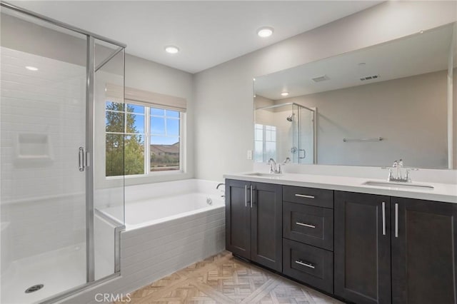 bathroom featuring a sink, double vanity, a shower stall, visible vents, and a bath