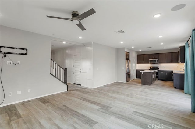 unfurnished living room featuring light wood-style floors, a ceiling fan, baseboards, recessed lighting, and visible vents