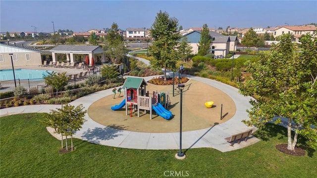 surrounding community featuring playground community, a yard, a residential view, and fence