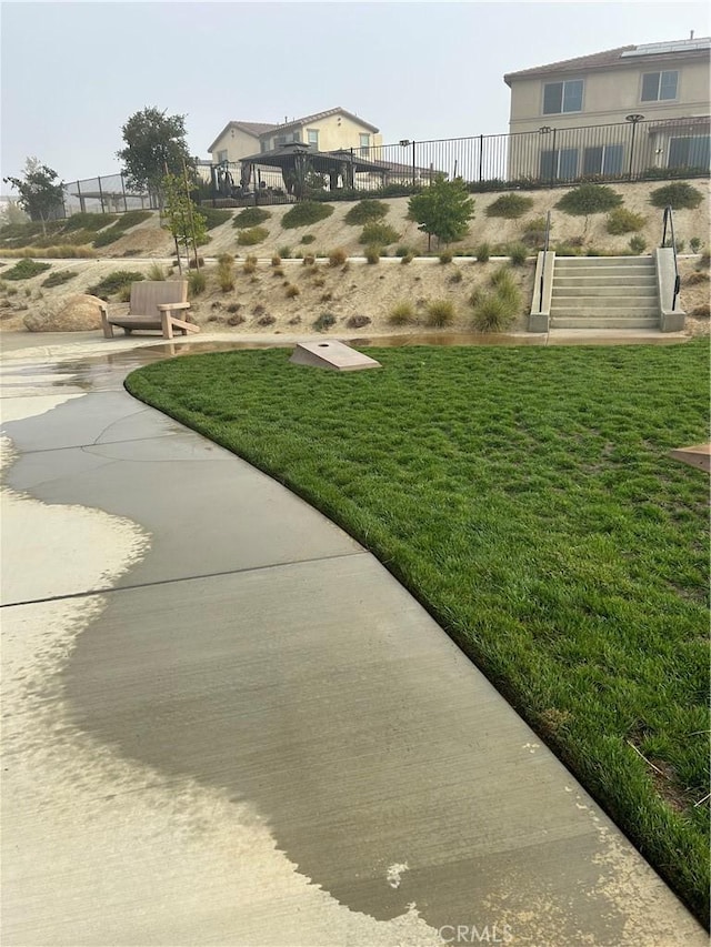 view of home's community featuring fence and a yard