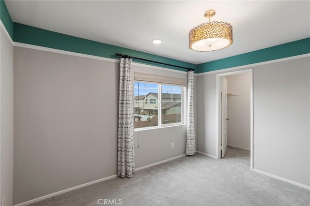 unfurnished bedroom featuring carpet floors, baseboards, and a closet