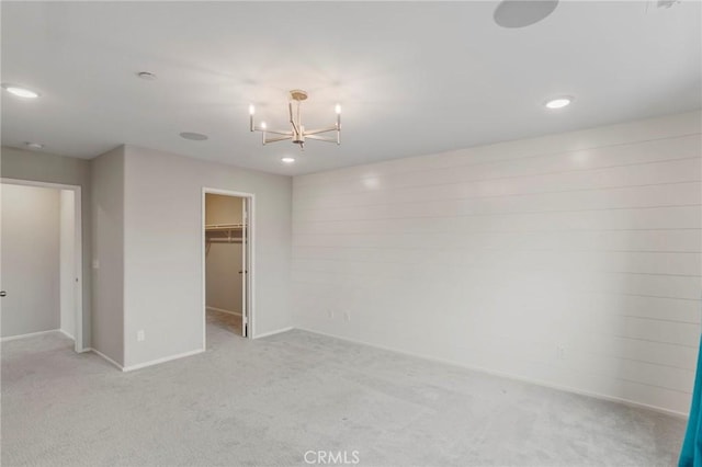 unfurnished bedroom with baseboards, carpet, recessed lighting, and a notable chandelier