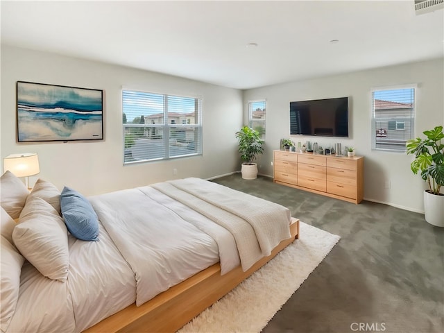bedroom featuring baseboards, visible vents, multiple windows, and carpet