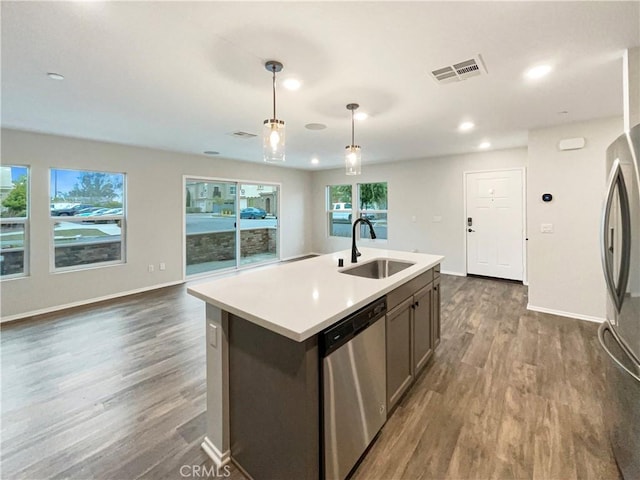 kitchen with visible vents, a sink, appliances with stainless steel finishes, and dark wood-style floors