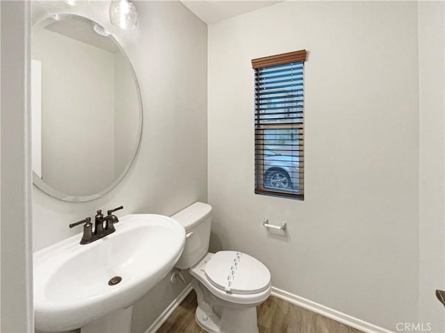 7155 Citrus Ave Unit 344, Fontana, CA 92336 - half bath featuring a sink, wood finished floors, baseboards, and toilet