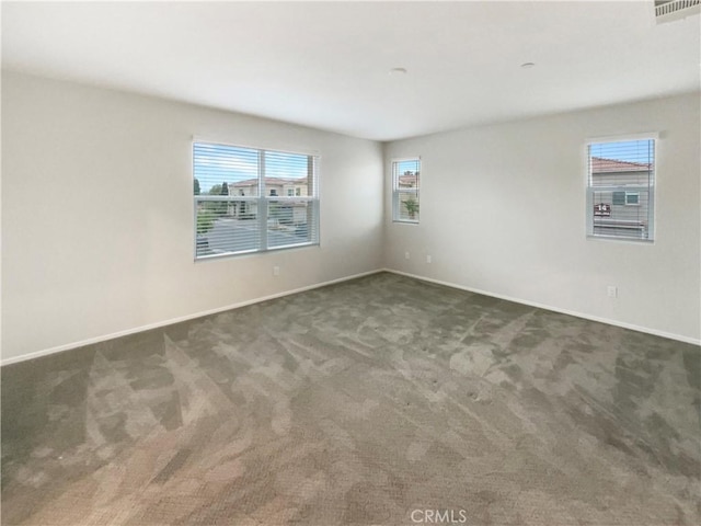 carpeted empty room with baseboards and visible vents