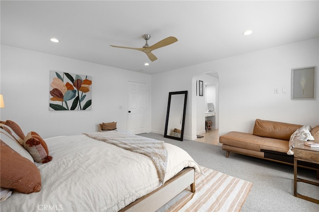 carpeted bedroom featuring arched walkways, recessed lighting, and a ceiling fan
