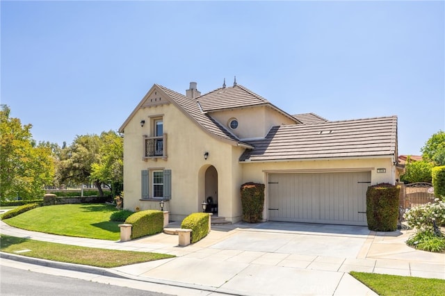 view of front of home featuring stucco siding, an attached garage, concrete driveway, a front lawn, and a balcony