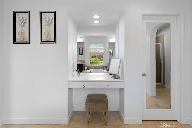 bathroom featuring a stall shower and baseboards