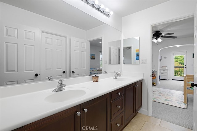 full bath featuring ensuite bath, double vanity, tile patterned flooring, and ceiling fan