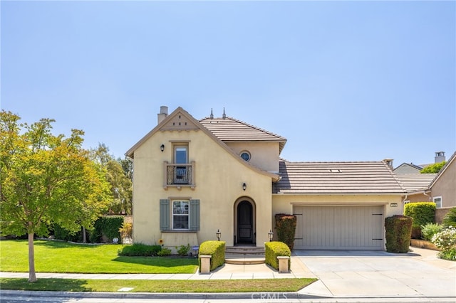 view of front facade with an attached garage, a front yard, driveway, stucco siding, and a chimney