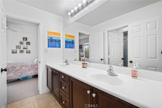 ensuite bathroom with tile patterned floors, double vanity, and ceiling fan