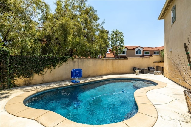 view of pool featuring a fenced backyard and a patio