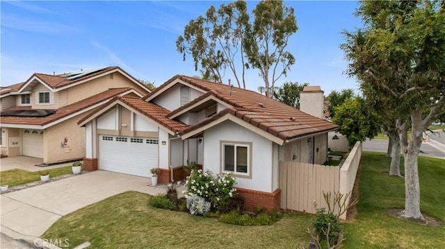 view of front of property with a front lawn, a chimney, a tiled roof, concrete driveway, and solar panels