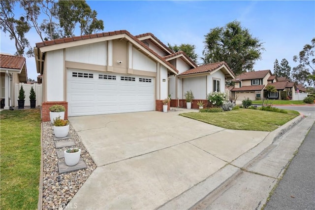 view of front of property with driveway, a tile roof, a front yard, brick siding, and an attached garage