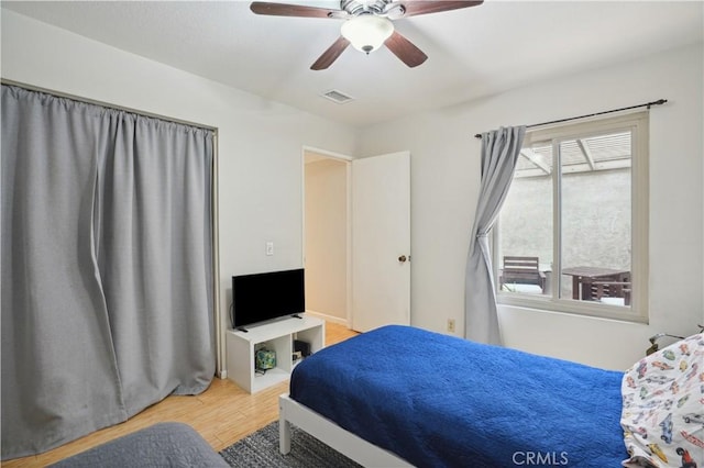 bedroom with visible vents, ceiling fan, and wood finished floors