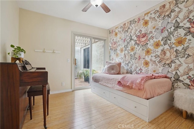 bedroom featuring access to outside, baseboards, ceiling fan, and wood finished floors