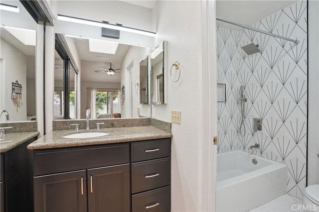 full bath with vanity, ceiling fan, and bathtub / shower combination