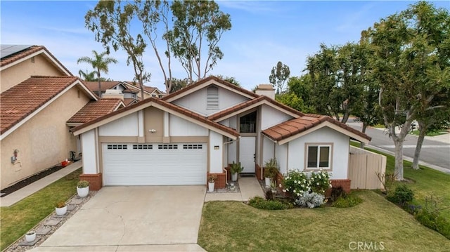 view of front of house featuring concrete driveway, stucco siding, a chimney, and a garage