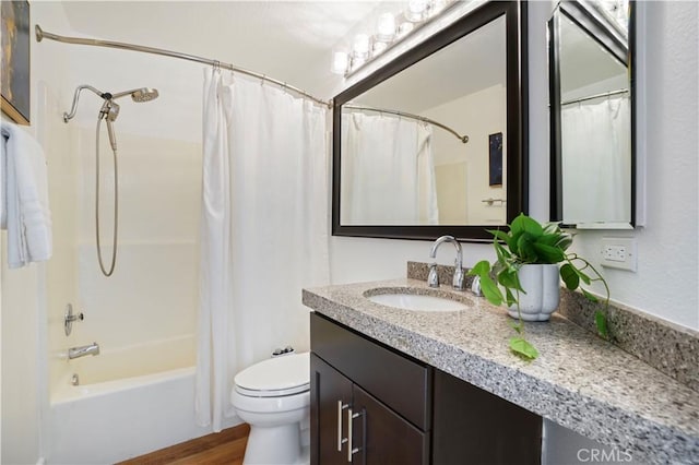 bathroom featuring toilet, shower / tub combo with curtain, wood finished floors, and vanity