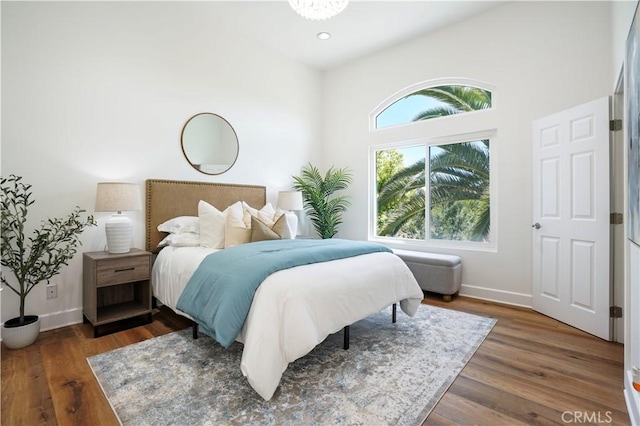 bedroom with baseboards, recessed lighting, and wood finished floors