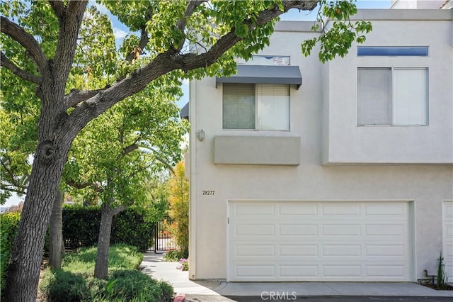view of front of property with stucco siding and a garage