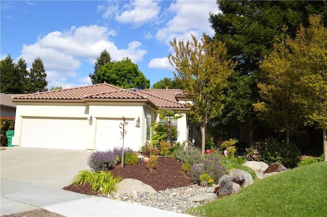 mediterranean / spanish-style home with concrete driveway, a tiled roof, a garage, and stucco siding