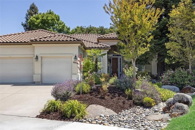 1042 Sleepy Hollow Rd, Paso Robles, CA 93446 - mediterranean / spanish-style home featuring a tiled roof, a garage, driveway, and stucco siding