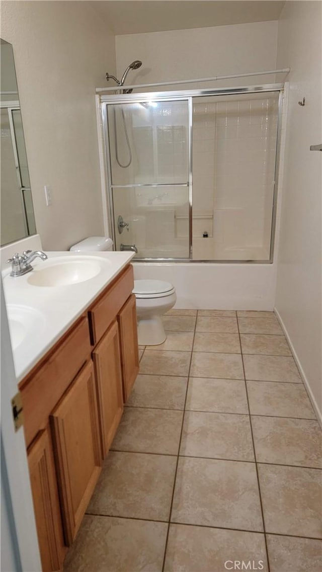 28799 Lavatera Ave, Murrieta, CA 92563 - full bath featuring toilet, tile patterned floors, a sink, and bath / shower combo with glass door