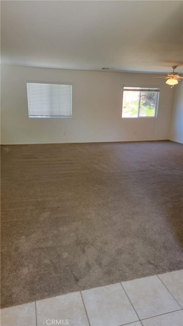 28799 Lavatera Ave, Murrieta, CA 92563 - spare room featuring a ceiling fan, light carpet, and light tile patterned floors