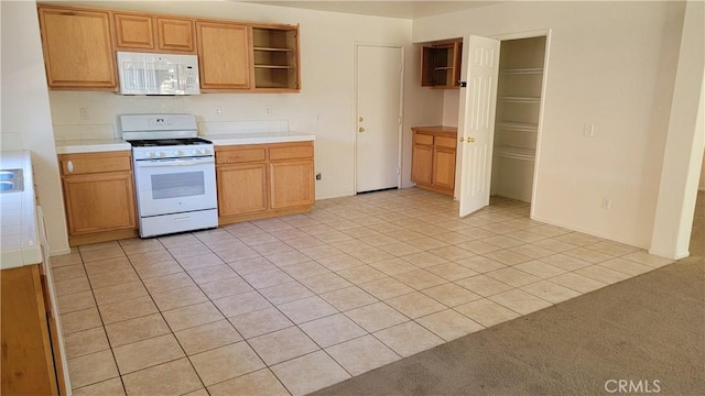 28799 Lavatera Ave, Murrieta, CA 92563 - kitchen with open shelves, light tile patterned floors, white appliances, and light countertops