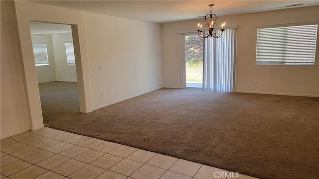 28799 Lavatera Ave, Murrieta, CA 92563 - spare room featuring an inviting chandelier, plenty of natural light, visible vents, and light colored carpet
