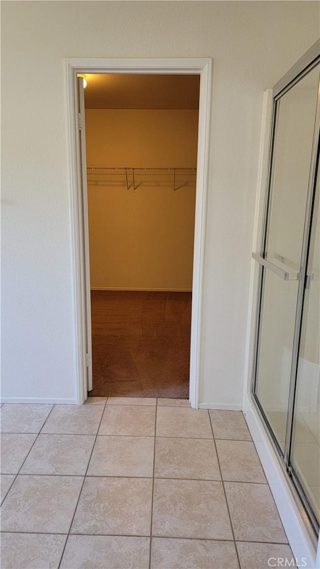 28799 Lavatera Ave, Murrieta, CA 92563 - hall with light tile patterned floors, baseboards, and light carpet