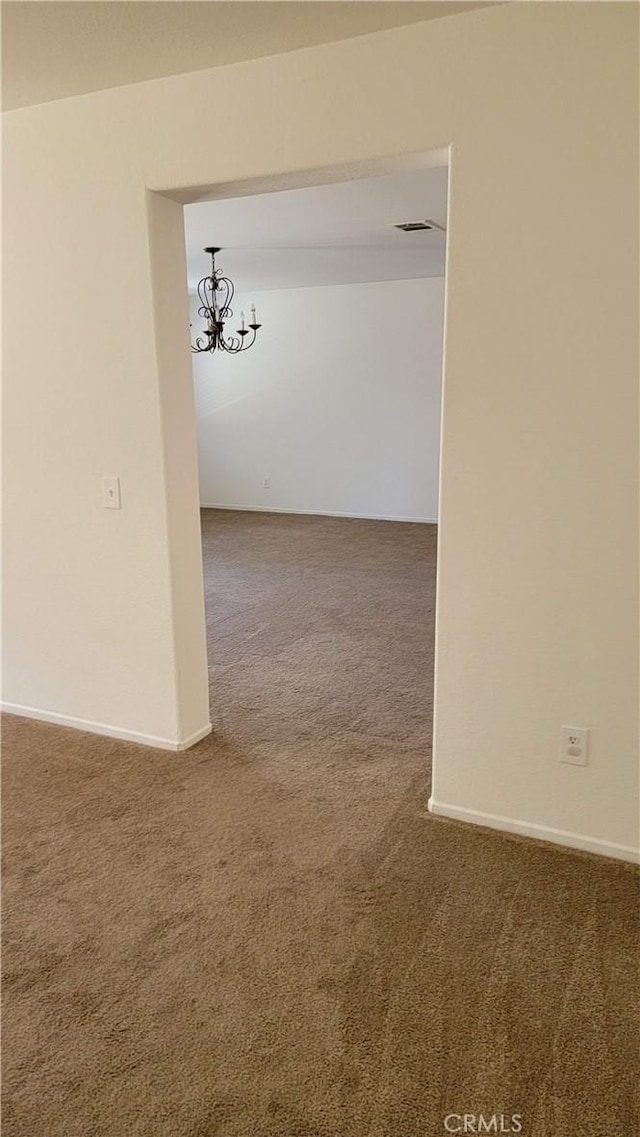 28799 Lavatera Ave, Murrieta, CA 92563 - empty room with visible vents, carpet flooring, baseboards, and a chandelier