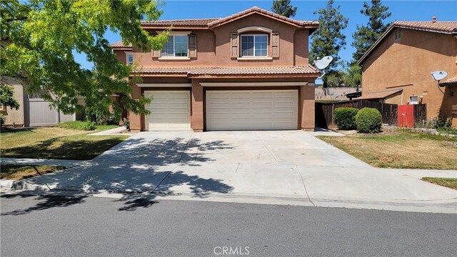 28799 Lavatera Ave, Murrieta, CA 92563 - view of front of home featuring fence, a tile roof, a garage, stucco siding, and concrete driveway