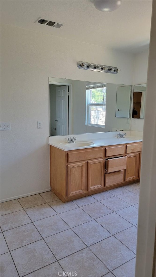 28799 Lavatera Ave, Murrieta, CA 92563 - bathroom with visible vents, a sink, tile patterned flooring, and double vanity