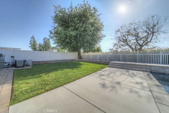 view of yard featuring a patio area and a fenced backyard