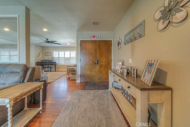 interior space with visible vents, baseboards, hardwood / wood-style floors, and recessed lighting