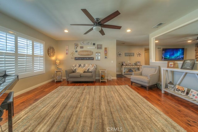 living room with ceiling fan, recessed lighting, visible vents, and wood finished floors