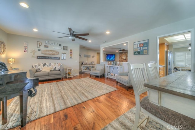living room featuring a ceiling fan, recessed lighting, and wood finished floors