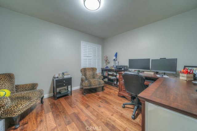 home office with wood finished floors and baseboards