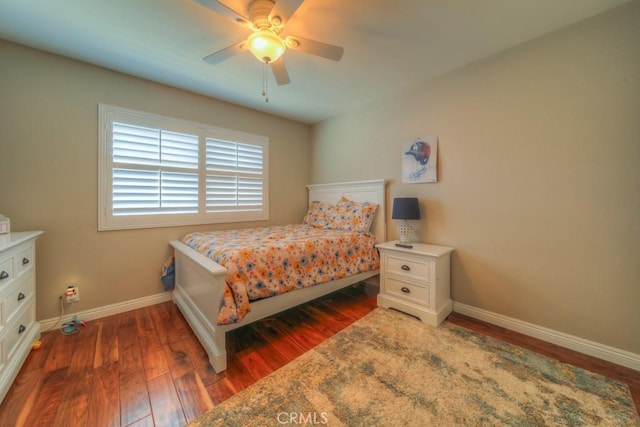 bedroom with baseboards, ceiling fan, and wood finished floors